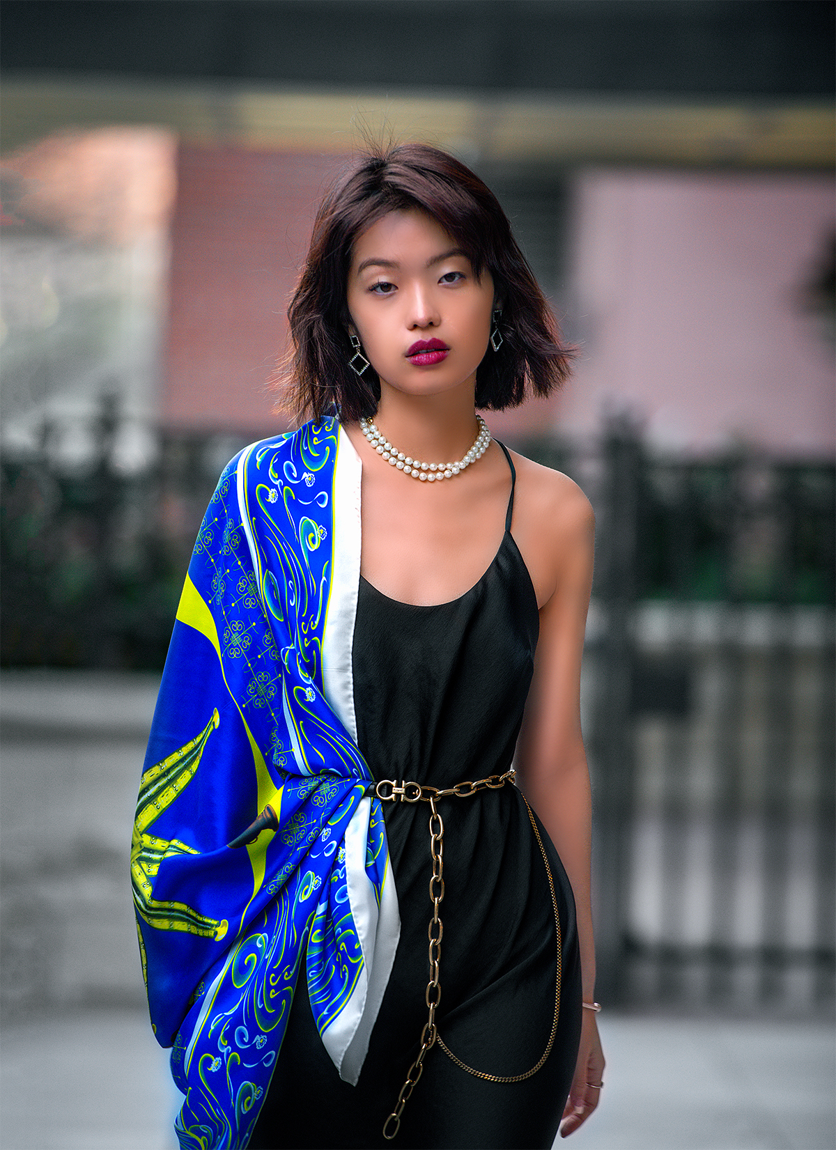 Model styled in black wearing the blue Axum Obelisk scarf